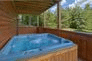 Private hot tub at cabin with wooded view