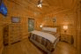 Cabin bedroom with King Bed and Wooded Views